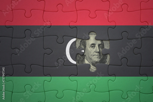 puzzle with the national flag of libya and usa dollar banknote. finance concept