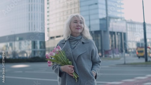 A portrait of a senior woman in cityscape