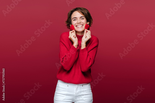 Happy romantic cute woman holding red hearts celebration Valentines day photo