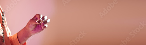 banner of cropped african american man holding cigarette paper with tabacco, bad habit concept