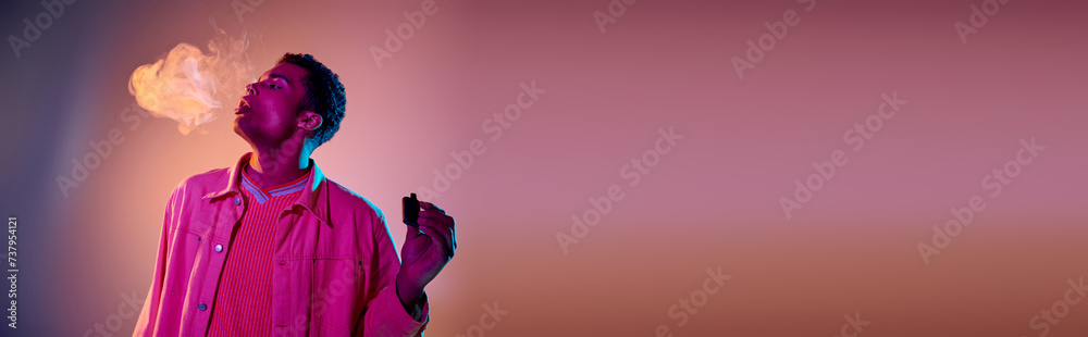 banner of african american man exhaling smoke while holding e cigarette on colorful background banner of african american man exhaling smoke while holding e cigarette on colorful background