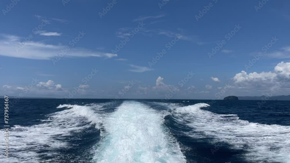White waves as a trail of a speedboat in the blue ocean with clear skies. White waves as a trail of a speedboat in the blue ocean with clear skies.