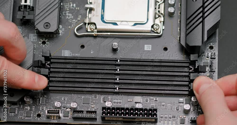 Installing two RAM modules into the motherboard slots. Assembling a ...