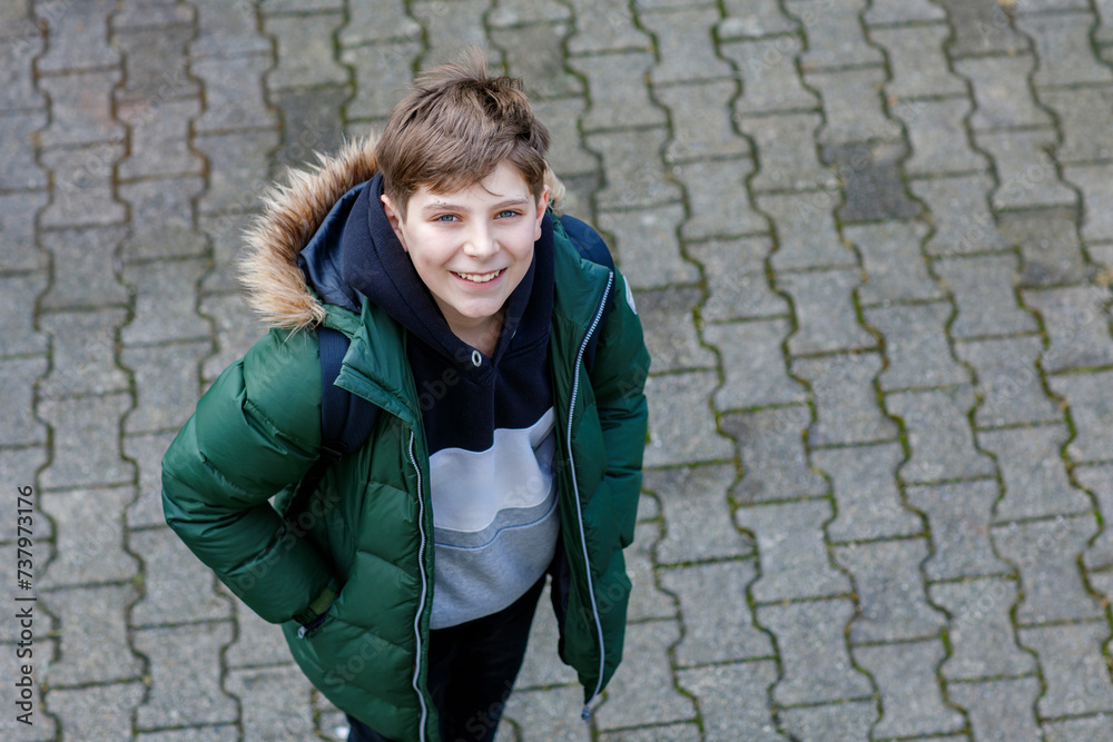 Closeup portrait of smiling smart school boy with backpack on the way from or to school. Happy teen child on the street. Teenager looking at camera. Education concept Closeup portrait of smiling smart school boy with backpack on the way from or to school. Happy teen child on the street. Teenager looking at camera. Education concept