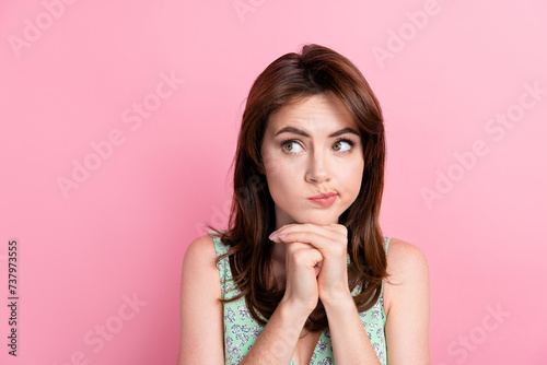 Photo of cute minded girl wear trendy clothes arm touch face look poster empty space seasonal news isolated on pink color background