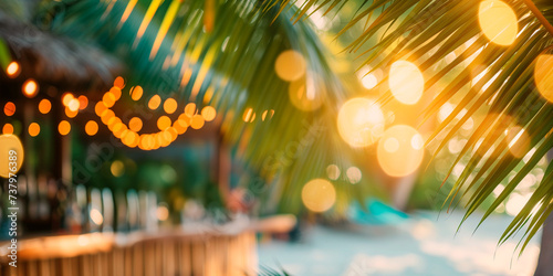 Blurred background blurred beach bar  framed by palm leaves photo