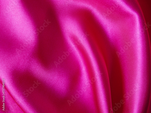 Pink silk or satin background, wavy, elegant and elegant. Close-up, background. Space for designblur or blurry photo