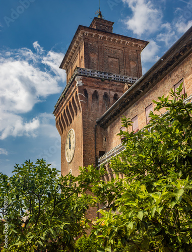 Ferrara, Emilia Romagna, Italy. The clock tower of the imposing Estense castle, built by the noble Este family. UNESCO World Heritage Site.