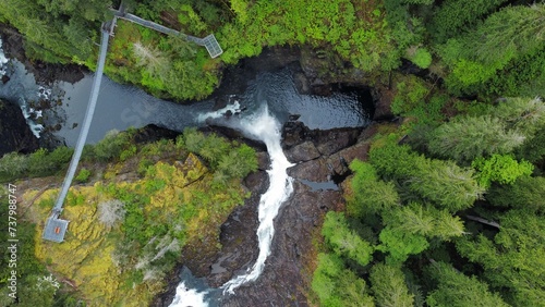 Looking down on waterfall into canyon suspension bridge