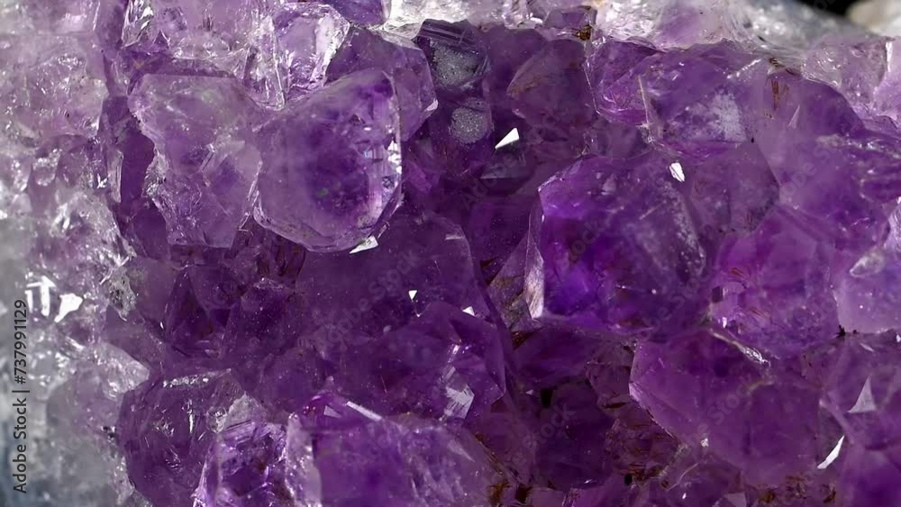 Amethyst crystals (purple quartz) sample rotating slowly against a black background. Amethyst crystals (purple quartz) sample rotating slowly against a black background.