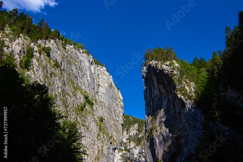 The limestone rocks towering over 1,000 ft. above the Bicaz Gorge (Romania: Cheile Bicazului).The gorge situated in the central part of the Hasmas Mountains and is part of the National Park in Romania photo