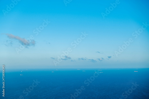 Tranquil Blue Ocean Waves under Majestic Sky with Clouds