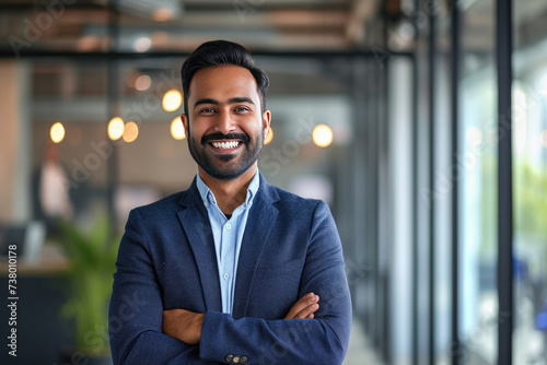 Cheerful Indian businessman with a bright smile in a modern workplace