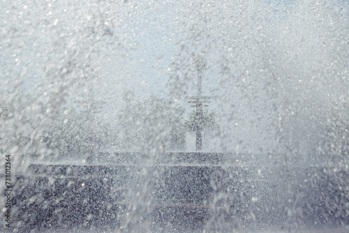 abstract splashes and drops of water in fountain  texture background. full frame. freshness on sunny hot day concept