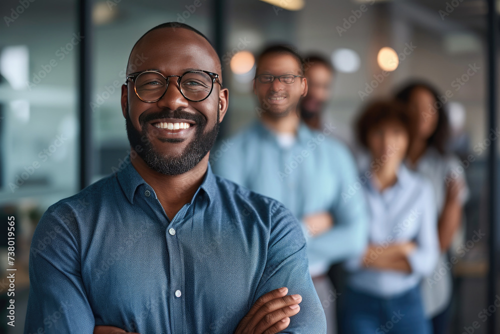 Handsome and confident African American businessman consultant smiling with diversity team in modern office background - obrazy, fototapety, plakaty 