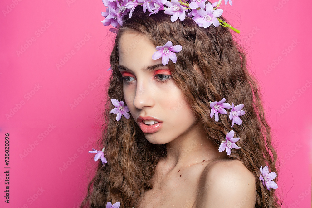 Beautiful girl with flowers in in hair