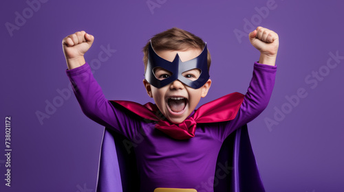 Joyful Boy in Superhero Costume with Raised Fists