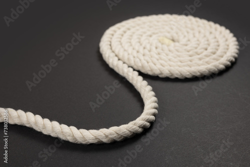 Coiled rope over a dark background