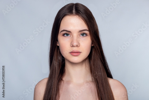 Beautiful Young Woman with Clean Fresh Skin touch own face .