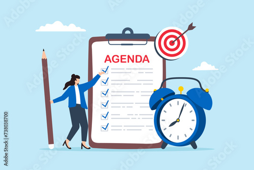 Businesswoman holding pencil and creating meeting agenda with alarm clock