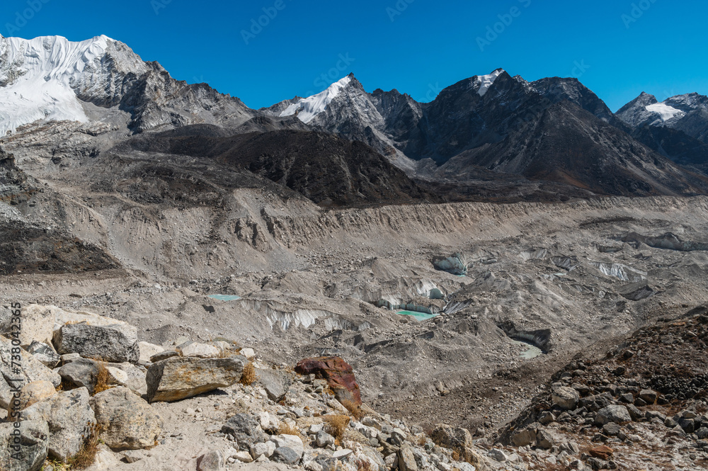 Cross over the Khumbu Glacier. View of stones, ice, snow and mountains  during Everest Base Camp EBC, Three Passes trekking in Khumjung, Nepal. Highest mountains in the world