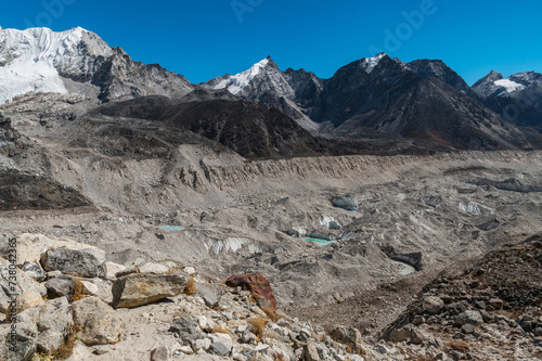 Cross over the Khumbu Glacier. View of stones, ice, snow and mountains during Everest Base Camp EBC, Three Passes trekking in Khumjung, Nepal. Highest mountains in the world