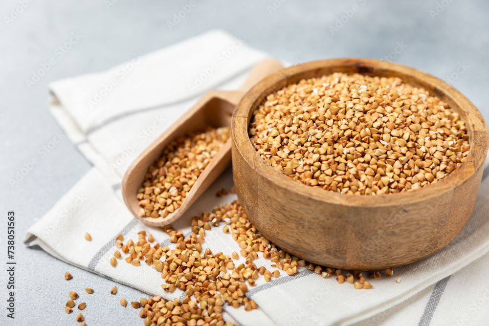 Green buckwheat in a bowl on a wooden kitchen table.Superfood.Raw buckwheat porridge.Healthy vegan food concept, eco products, diet. Copy space.Organic food.weight loss and proper nutrition. Green buckwheat in a bowl on a wooden kitchen table.Superfood.Raw buckwheat porridge.Healthy vegan food concept, eco products, diet. Copy space.Organic food.weight loss and proper nutrition.