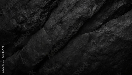 A close-up of dark, rugged rock textures, highlighting the intricate patterns and deep shadows, Ideal for backgrounds, nature themes, or abstract art.