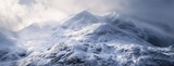 Majestic Snow-Covered Mountains Under Cloudy Skies