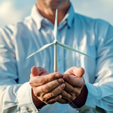 Man holding a wind turbine in his hands
