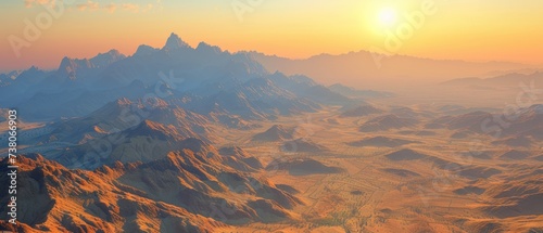 an aerial view of a mountain range with the sun rising over the top of the mountain range in the distance.