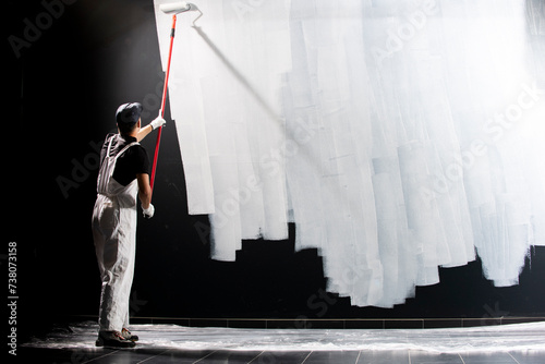 Male decorator painting a wall