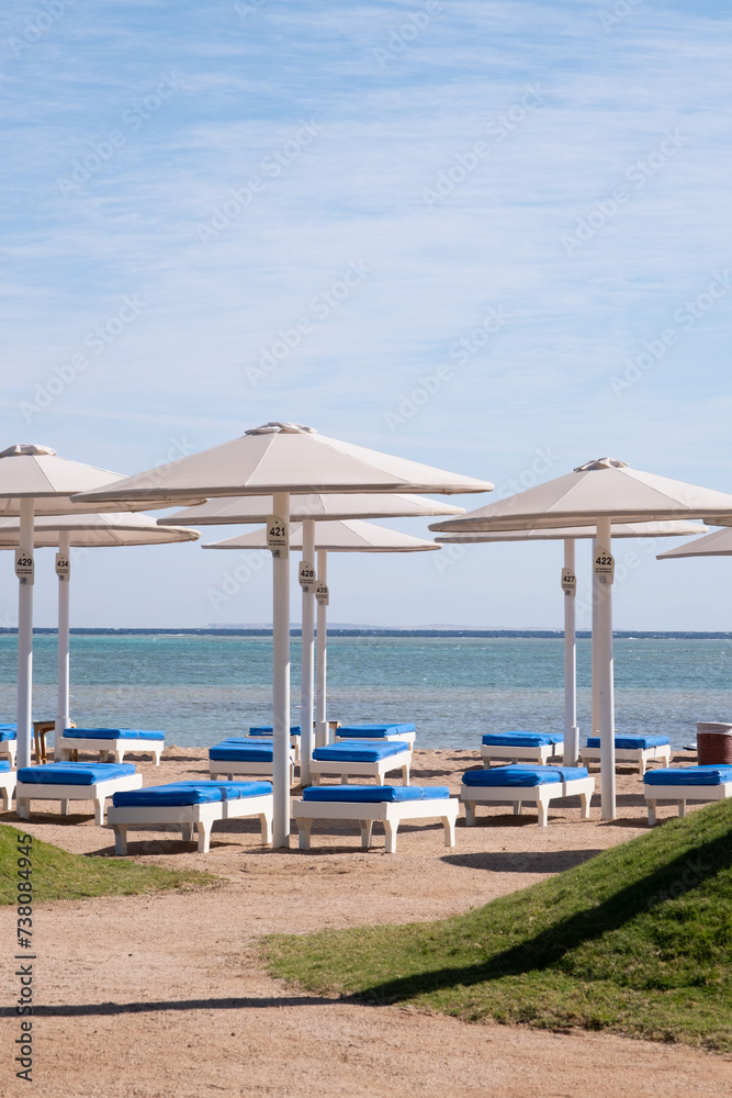 Empty beach with umbrellas and sun loungers
