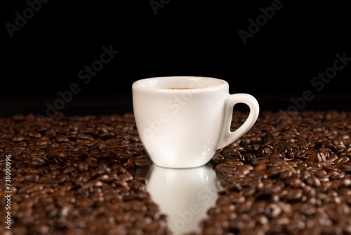 espresso coffee in white cup and coffee beans background