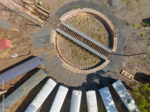 Aerial view of long train carriages lined up around a railway turntable photo