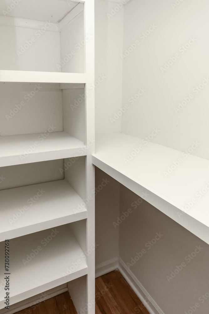 Interior white solid wood closet with wood shelves Interior white solid wood closet with wood shelves