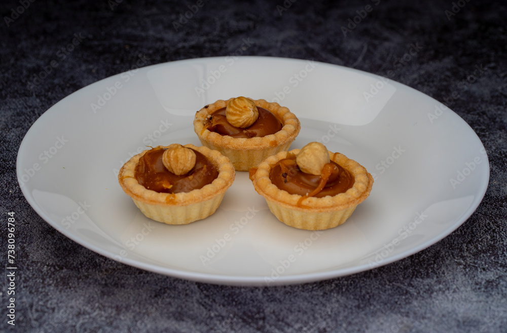 Mini tart. Fresh tartlets with caramel hazelnuts.
