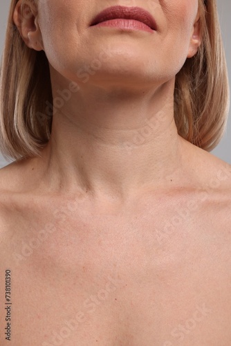 Woman with healthy skin on grey background, closeup