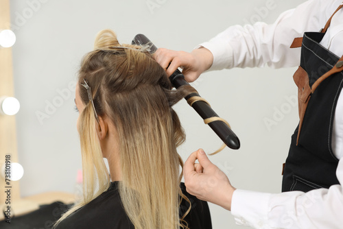 Wallpaper Mural Hair styling. Hairdresser curling woman's hair in salon, closeup Torontodigital.ca