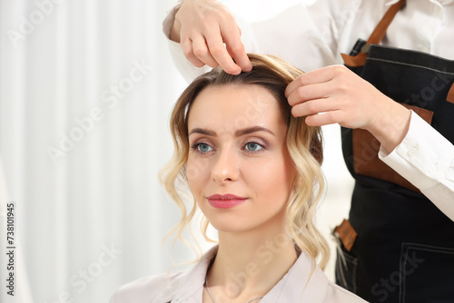 Hair styling. Professional hairdresser working with client in salon  closeup. Space for text