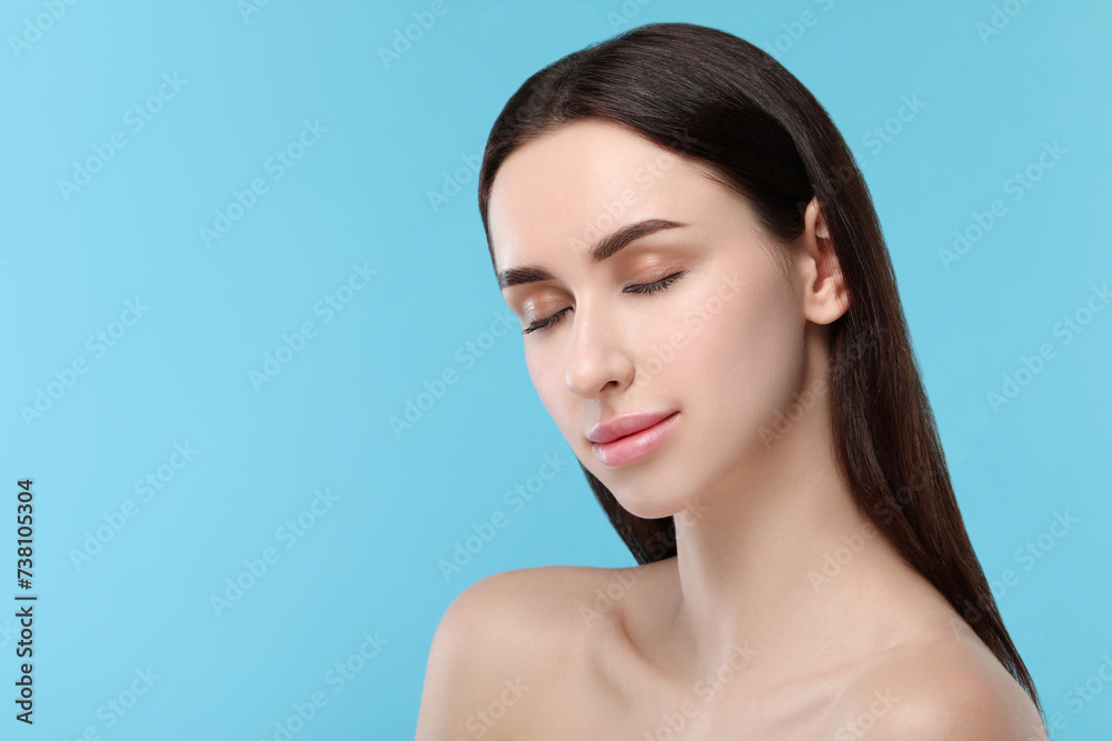 Portrait of beautiful young woman on light blue background. Space for text Portrait of beautiful young woman on light blue background. Space for text