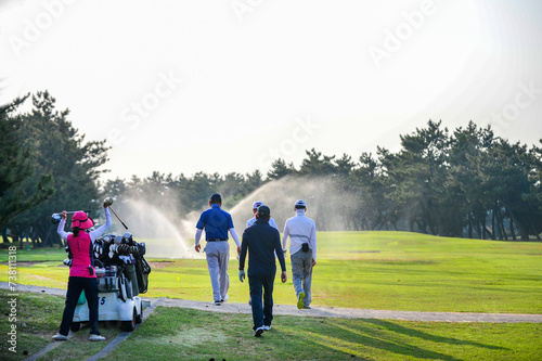 Golfer and Caddie playing golf on Golf Course