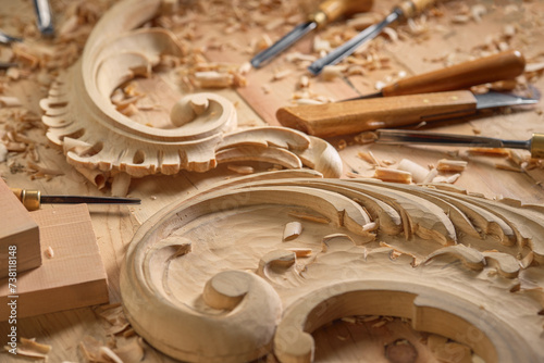 Carving wooden furniture. Carpenter using tool making artistic wood carving.