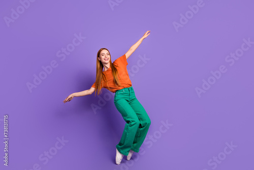 Photo of adorable positive girl wear trendy clothes have fun good mood friday party isolated on purple color background