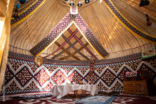 Central Asian yurt interior with traditional felt carpets and furniture