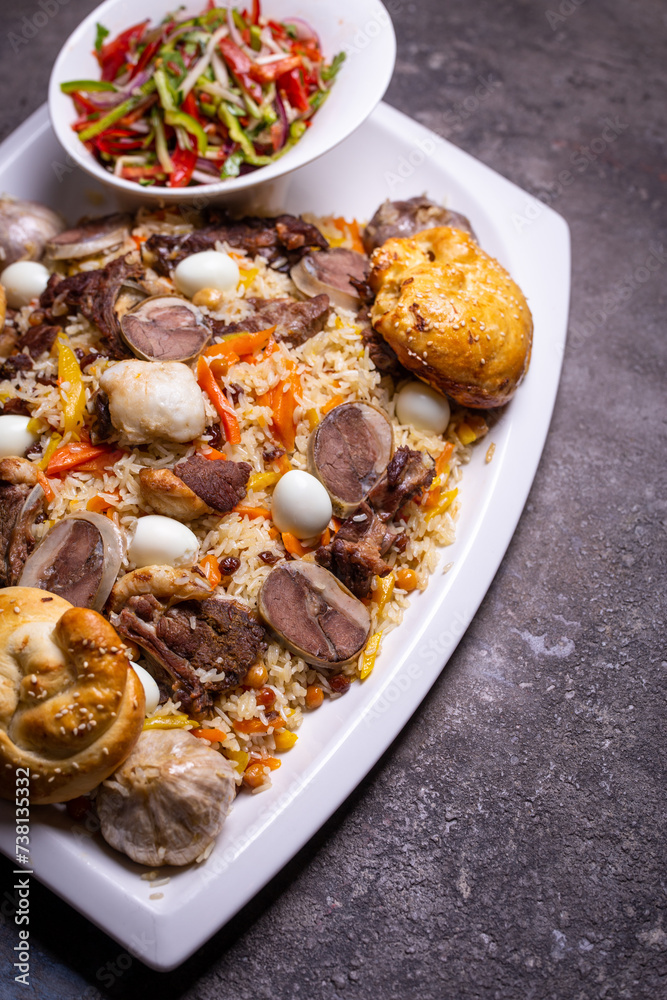 Traditional Uzbek Plov Dish with Mutton, Carrots, and Rice on White Plate. Traditional Uzbek Plov Dish with Mutton, Carrots, and Rice on White Plate.