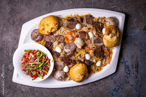 Traditional Uzbek Plov Dish with Mutton, Carrots, and Rice on White Plate.
