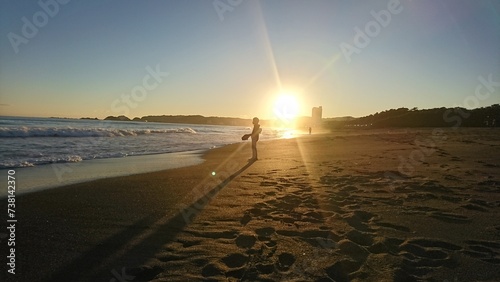 夕暮れの浜辺より　夕焼け　夕陽と男の子 photo