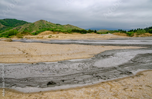 Фотография Muddy water has formed a substantial sand puddle