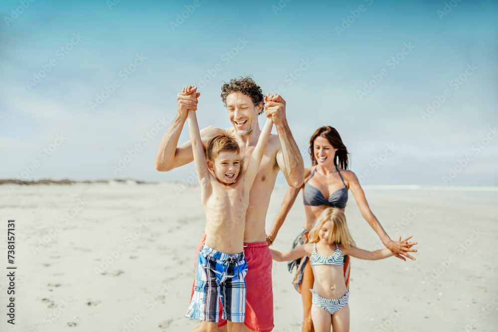 Happy family walking on sunny beach Happy family walking on sunny beach